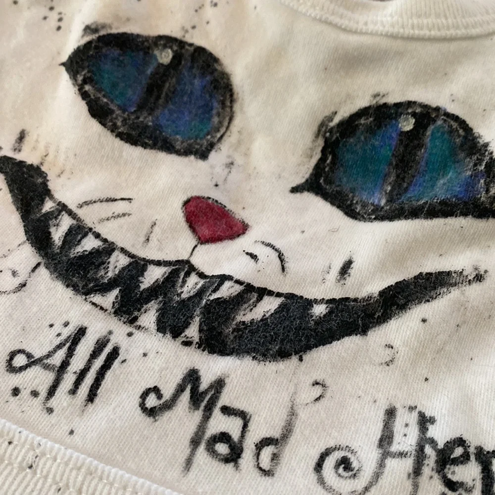 Alice in wonderland “precious one we’re all mad here!” Baby bib